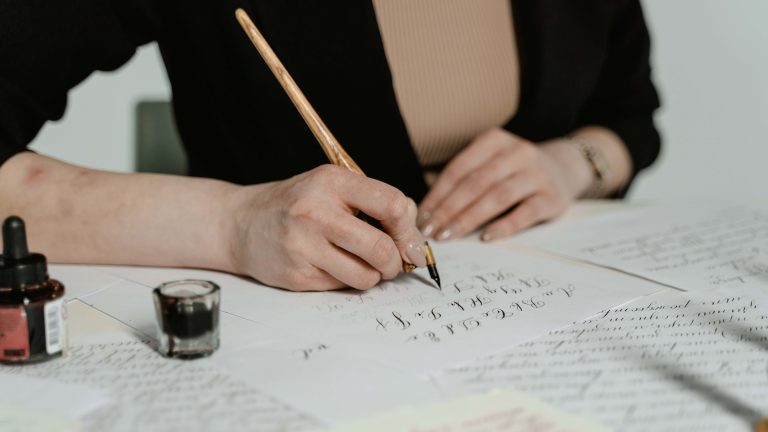 mage of a young girl focused and immersed in the art of calligraphy. She holds a pen poised over paper, her concentration evident in her posture. The delicate strokes and curves of her letters showcase her dedication to practicing the craft.